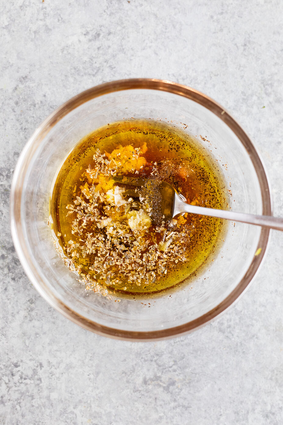 Homemade Italian salad dressing made with olive oil, vinegar, honey, herbs, garlic, and Dijon mustard