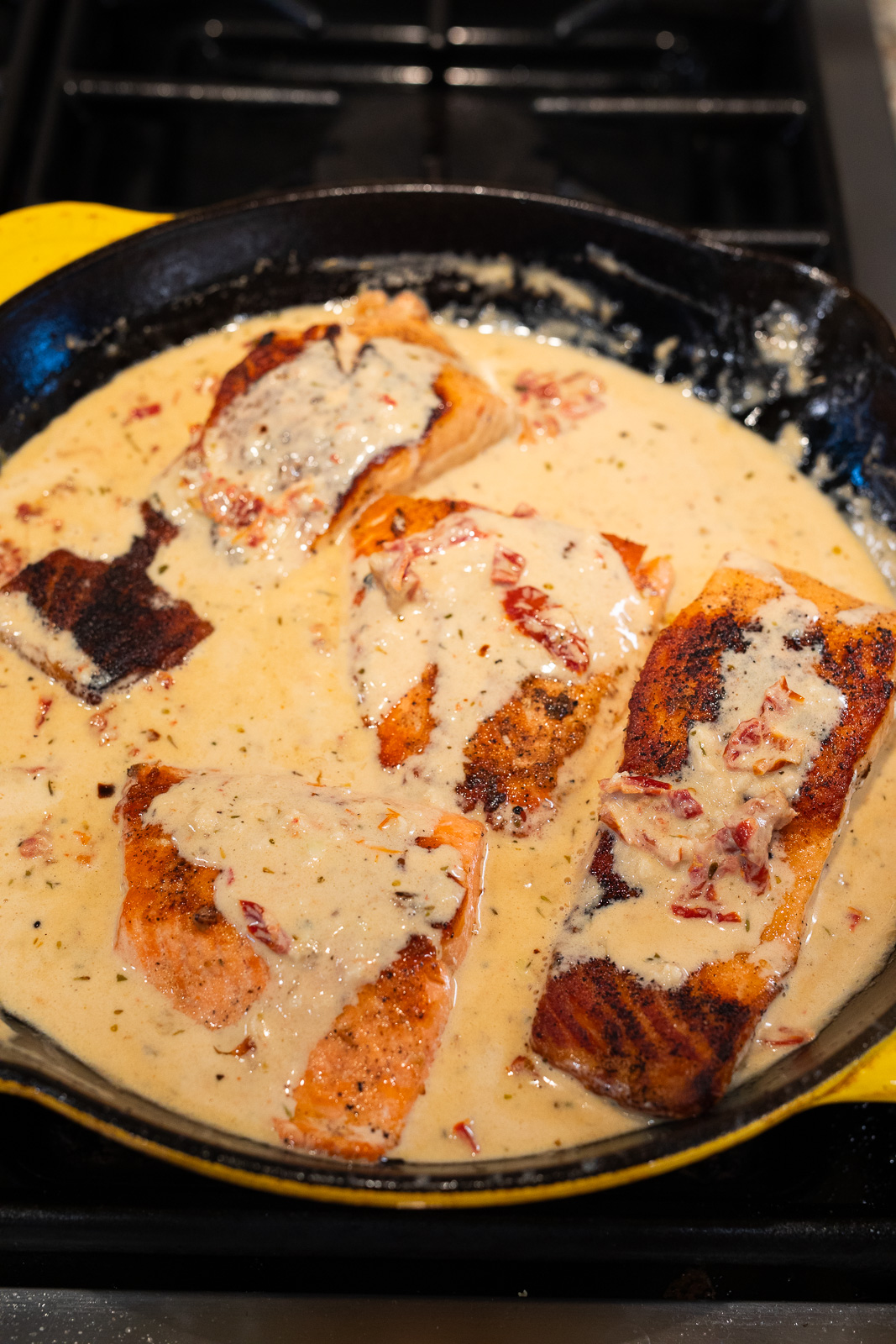 finishing the salmon in the creamy sauce