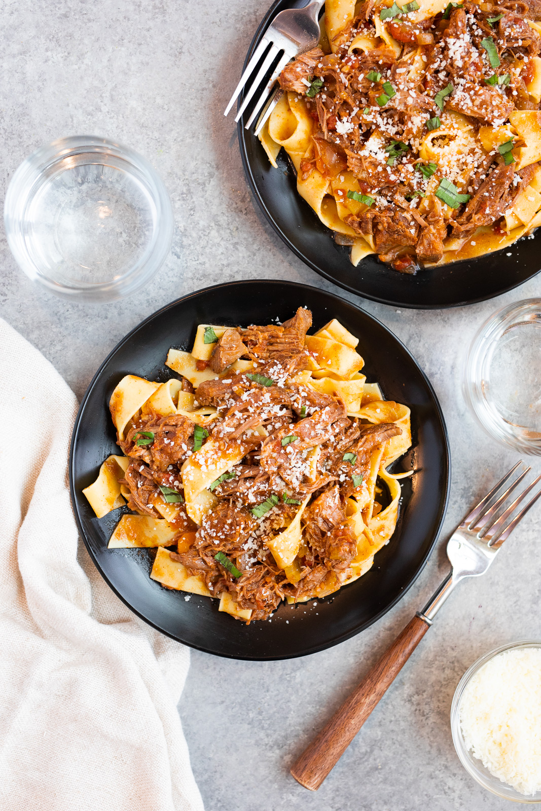 plates with tender beef ragu and pappardelle pasta