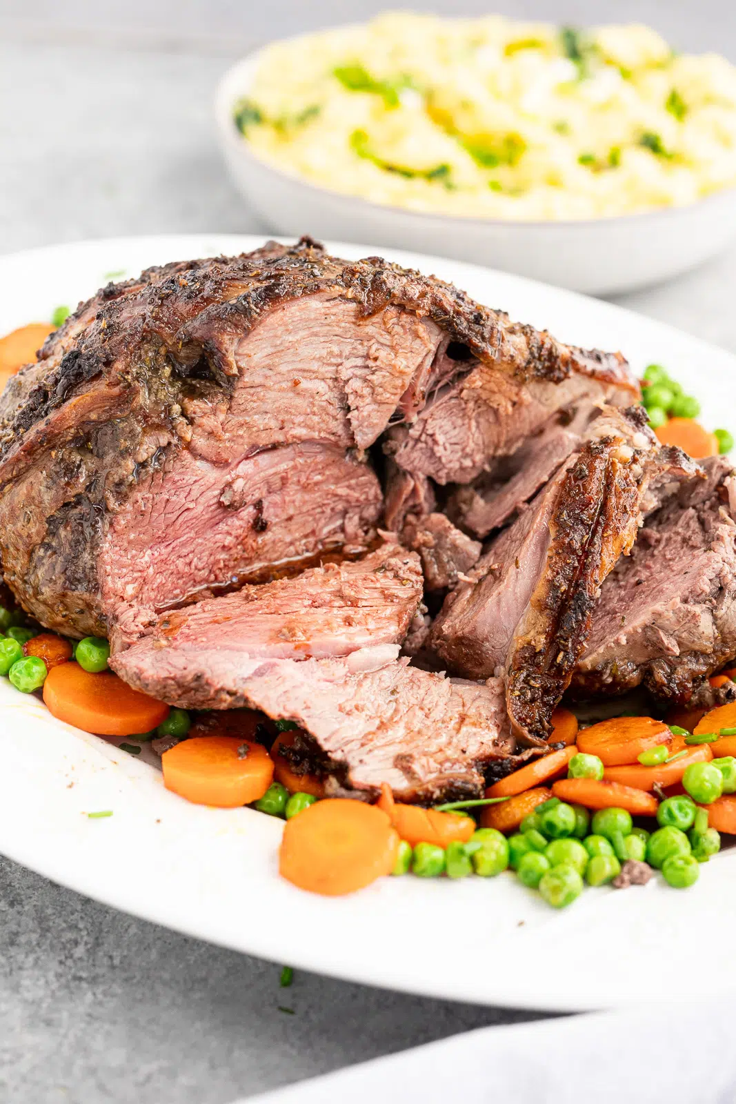 Juicy sliced roasted leg of lamb showing tender slightly pink center