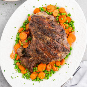 Roasted lamb leg with garlic, rosemary, and thyme served with vegetables and mashed potatoes
