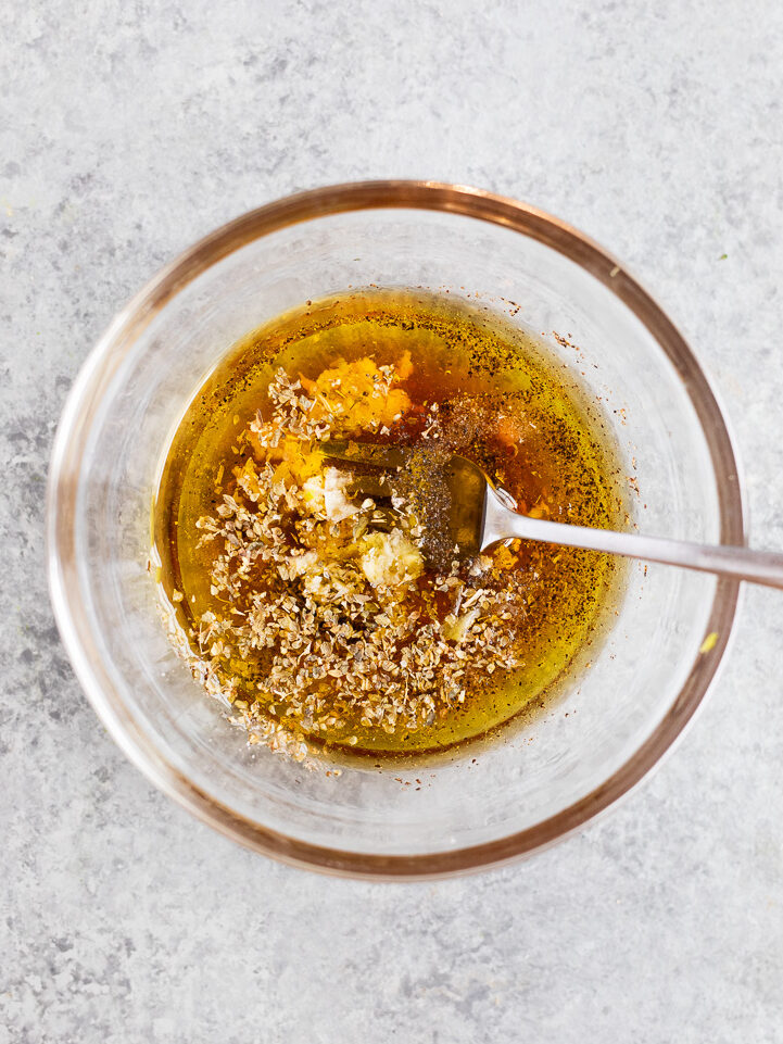 Olive oil vinaigrette with garlic, oregano, red wine vinegar, and lemon juice for Greek maroulosalata