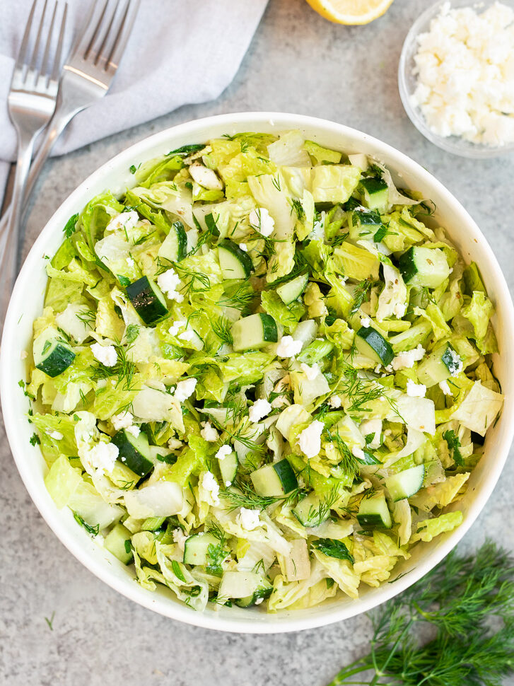 Traditional maroulosalata Greek lettuce salad tossed with cucumber, dill, feta and tangy vinaigrette
