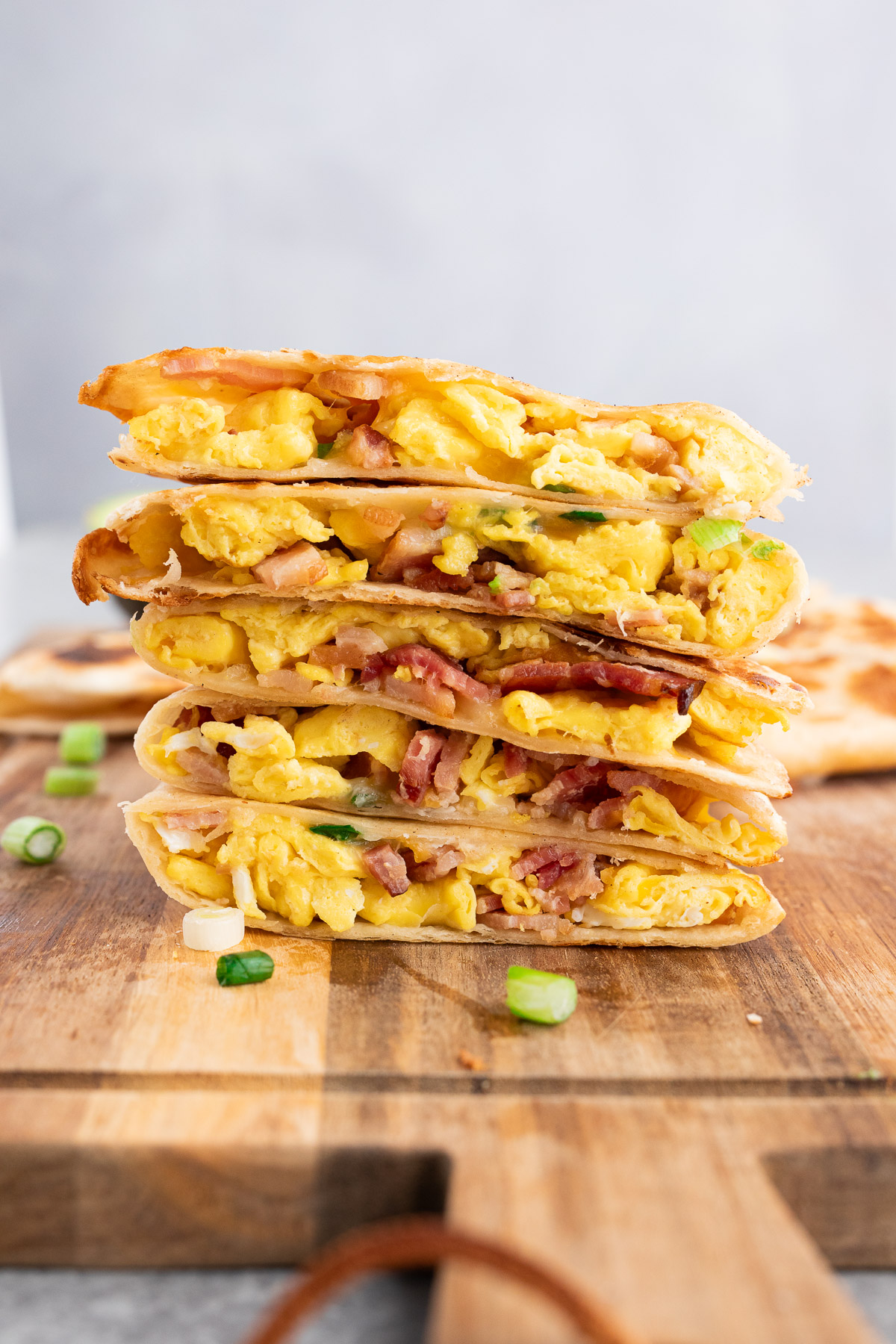 stacked breakfast quesadillas wedges on a cutting board