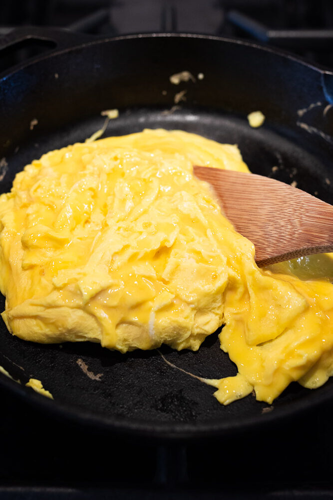 scrambling eggs in a cast iron skillet