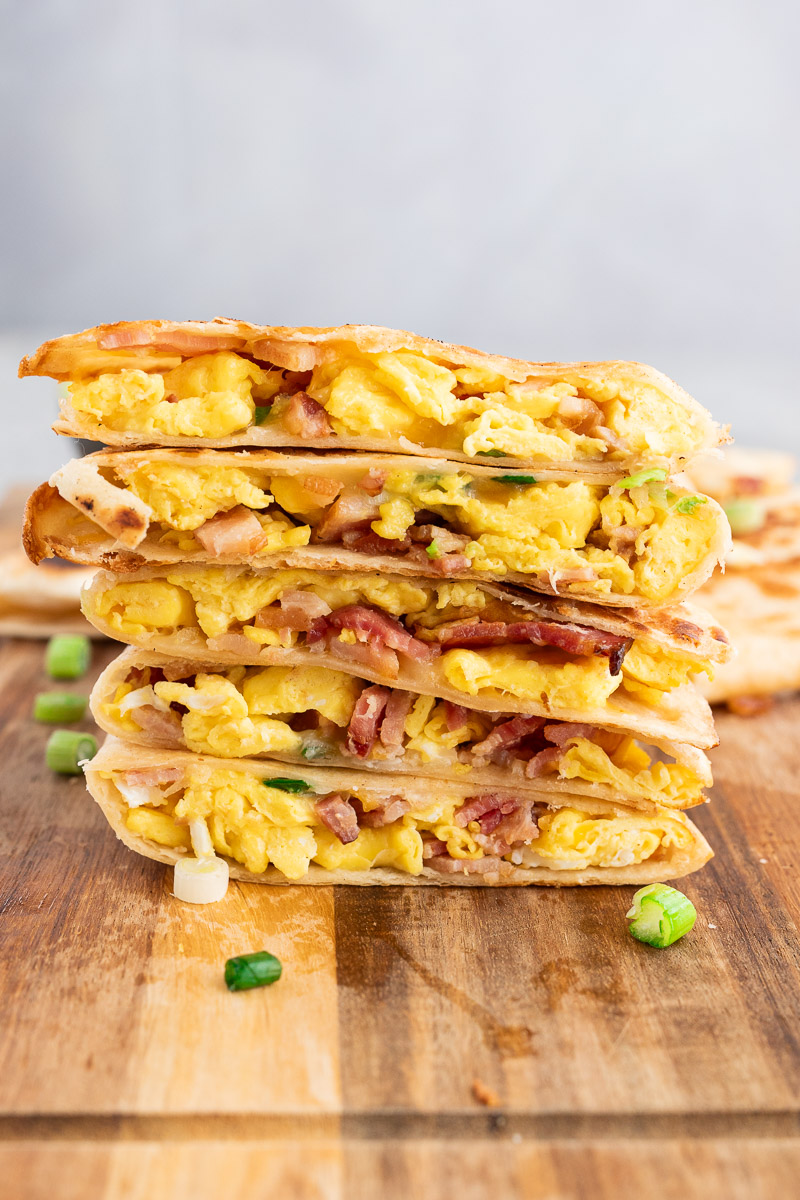 stacked breakfast quesadillas wedges on a cutting board